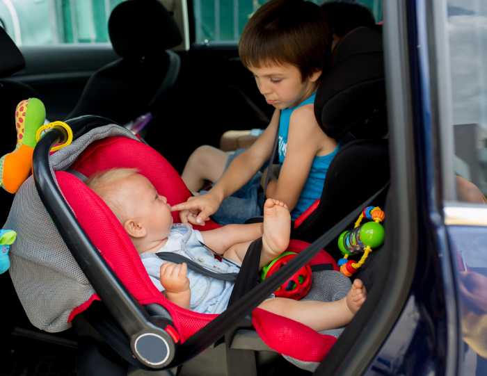 A baby in a car seatDescription automatically generated with low confidence
