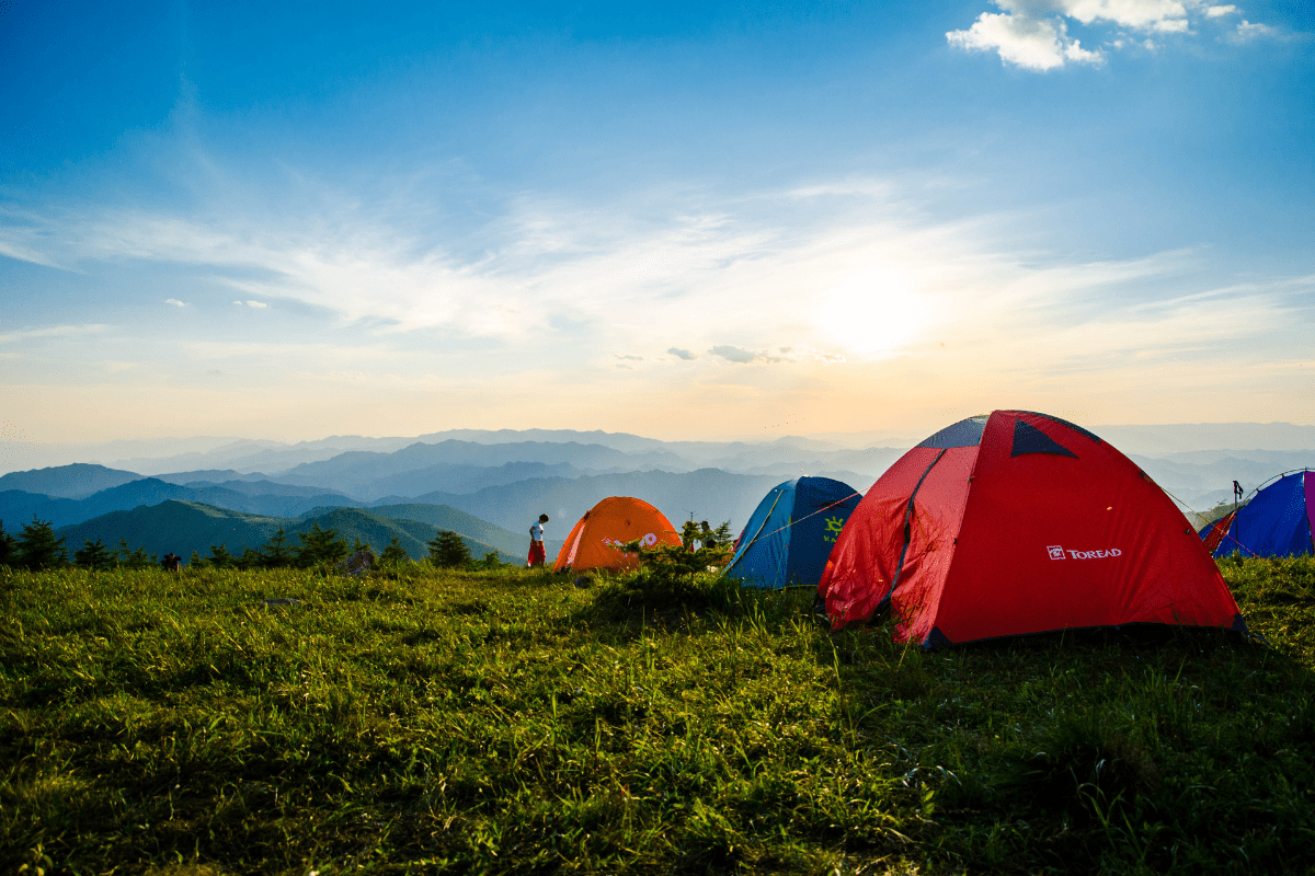 camping tents overlooking mountain ranges