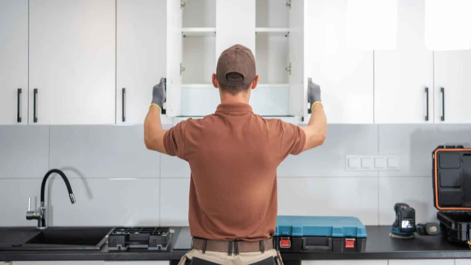A man opening kitchen cabinet