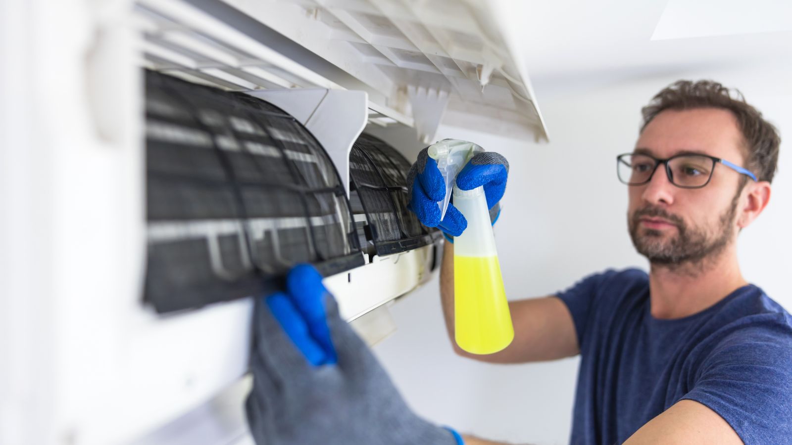 Man Cleaning AC