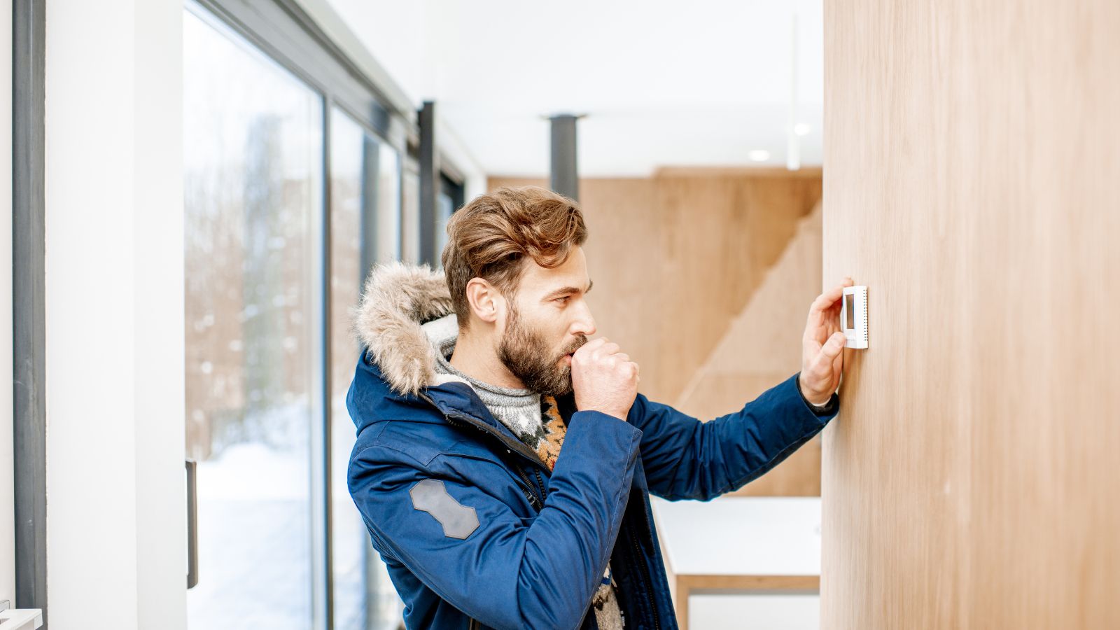 Man Setting Thermostat