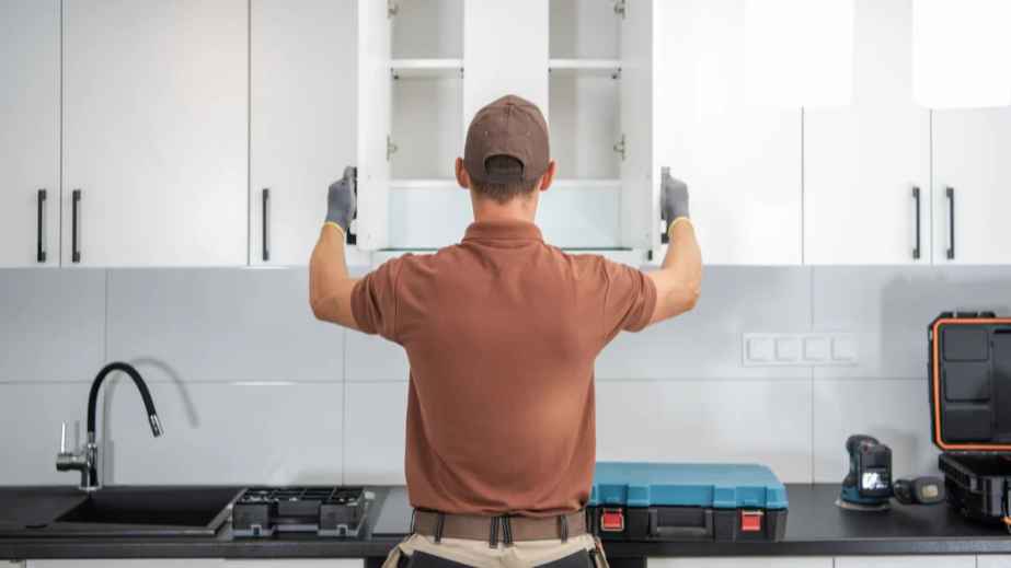 man holding a kitchen cabinet