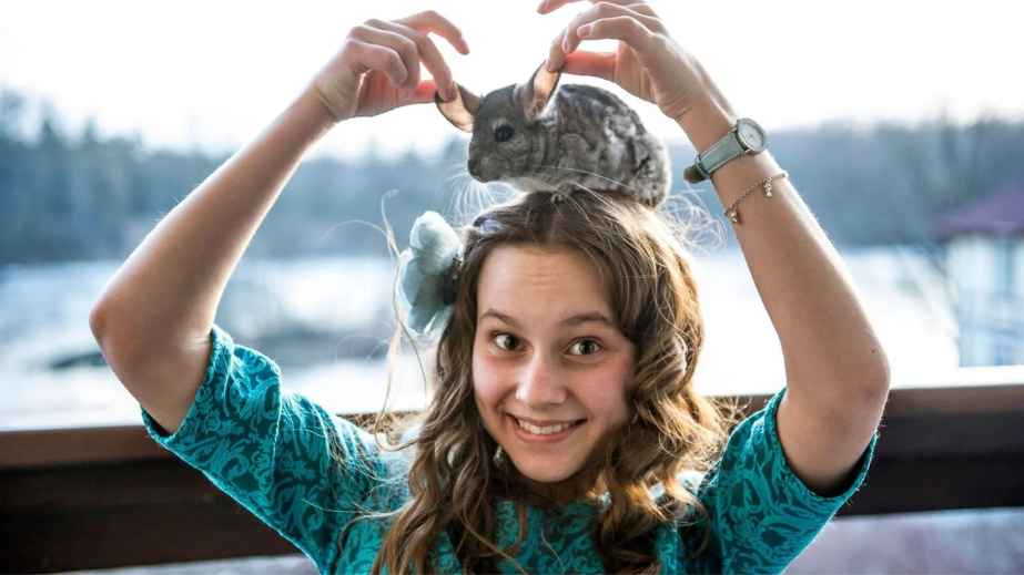 woman carrying a chinchilla