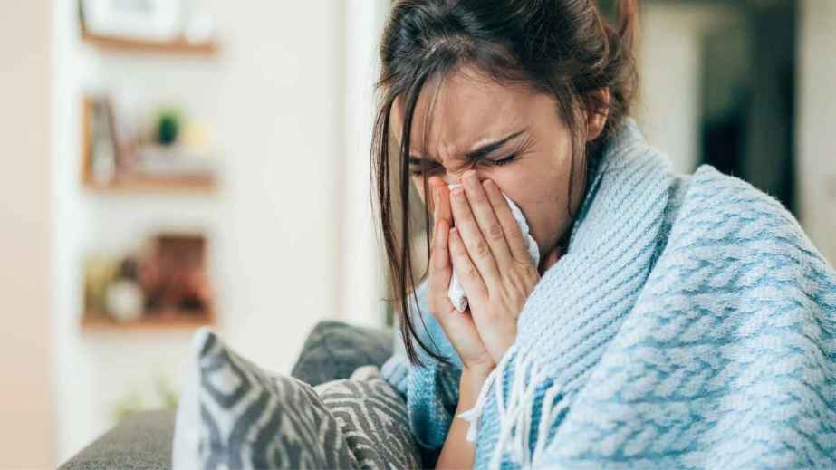 a woman blowing her nose