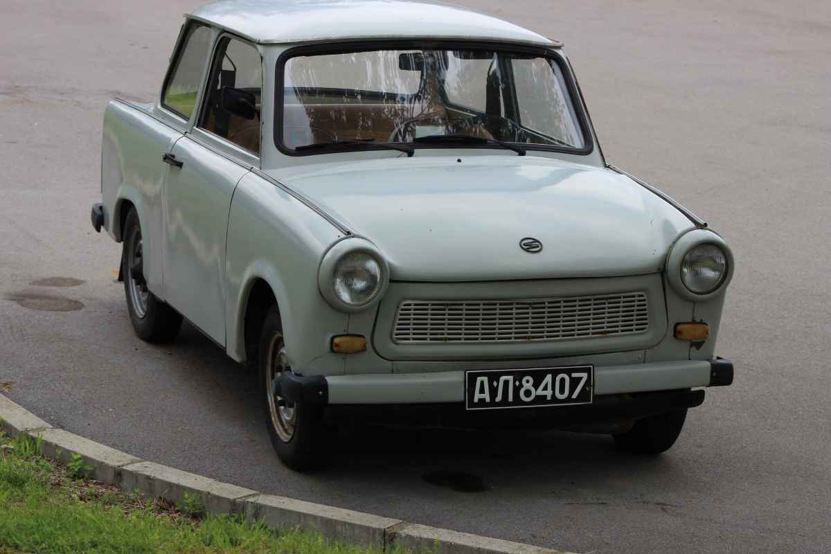 The Trabant, manufactured in East Germany during the Cold War era, has often been criticized as one of the worst cars ever produced. It was built with an underpowered, smoky two-stroke engine and a body made of Duroplast, a hard plastic composed of cotton waste and phenol resins. The car's poor performance, high pollution emissions, and comically austere design, combined with an astonishingly long wait time for delivery (sometimes up to a decade), have contributed to its notorious reputation. Despite its status as an icon of the former East Germany, the Trabant is invariably viewed as a symbol of the failings of centralized planning and the inefficiencies of the Communist system.