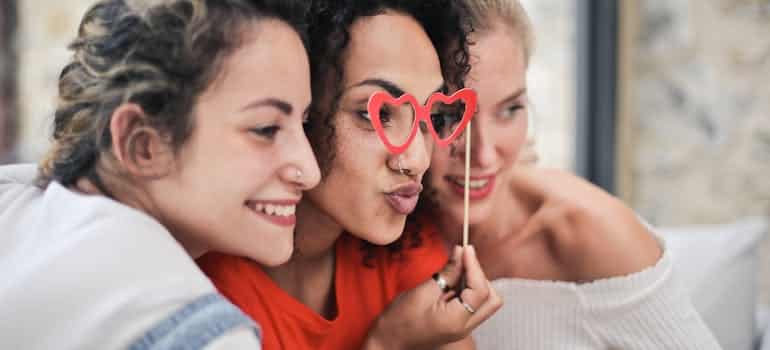 three women smiling and posing for a photo