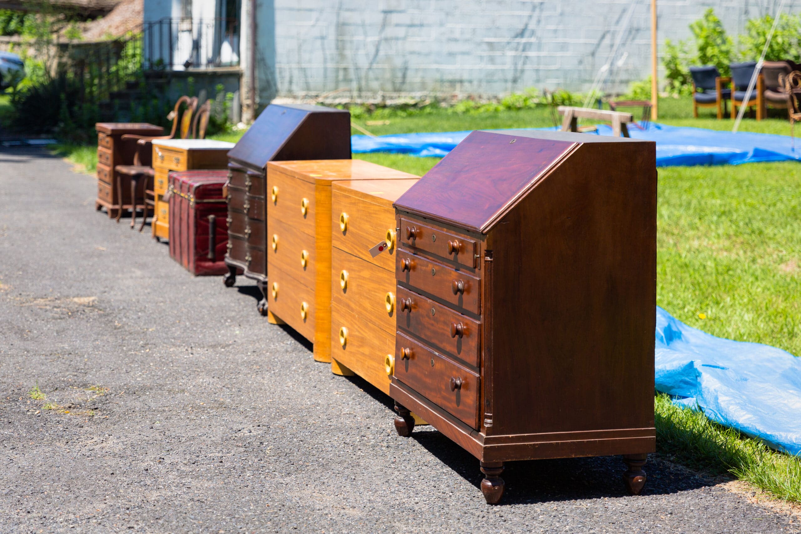 A variety of antique wooden cabinets on the grass
